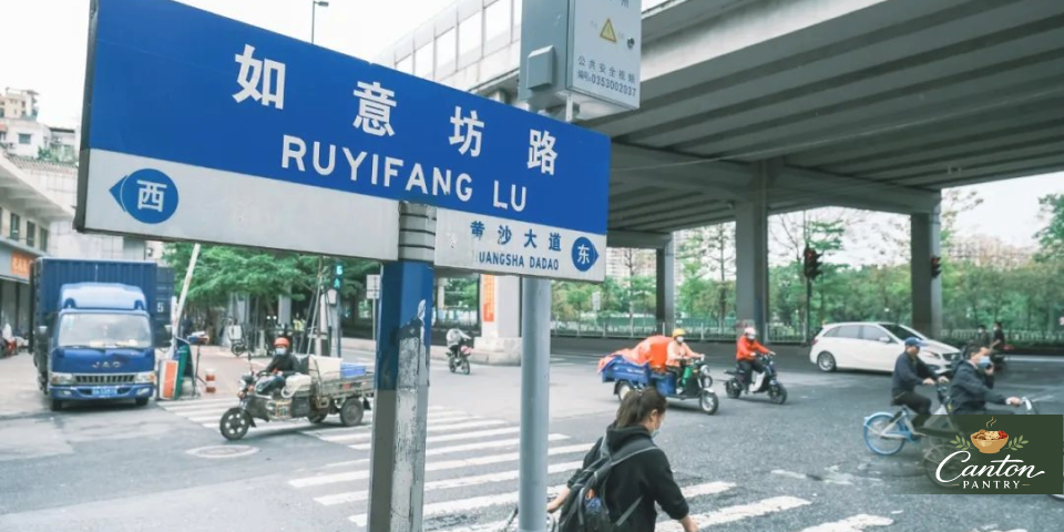 Wide view of the Ruyifang Road sign, scooters, and traffic under the flyover