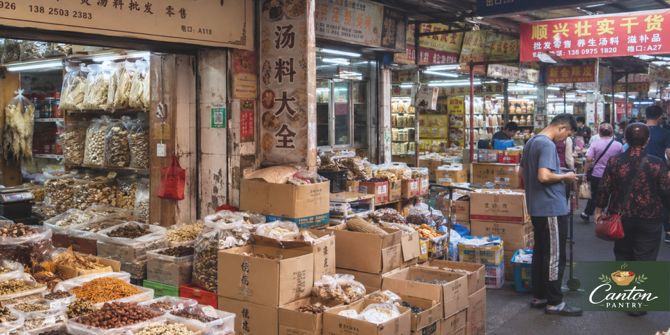 Market aisle in Ruyifang with soup ingredients, dried goods, cartons, and shoppers